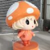 Close-up shot custom cartoon mushroom girl FRP mascot, childlike character sculpture for theme park photo spot decoration