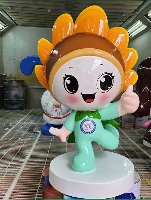 Spray workshop photo of sunflower cartoon fiberglass mascot sculpture, big orange sunflower petal head, mint green suit, thumbs-up pose on white round base