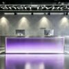 Modern stainless steel LED reception desk with purple gradient light panel for dance studio front lobby