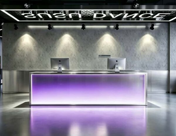 Modern stainless steel LED reception desk with purple gradient light panel for dance studio front lobby