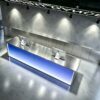 Top view of RGB light up reception counter, brushed stainless steel tabletop for gym front desk