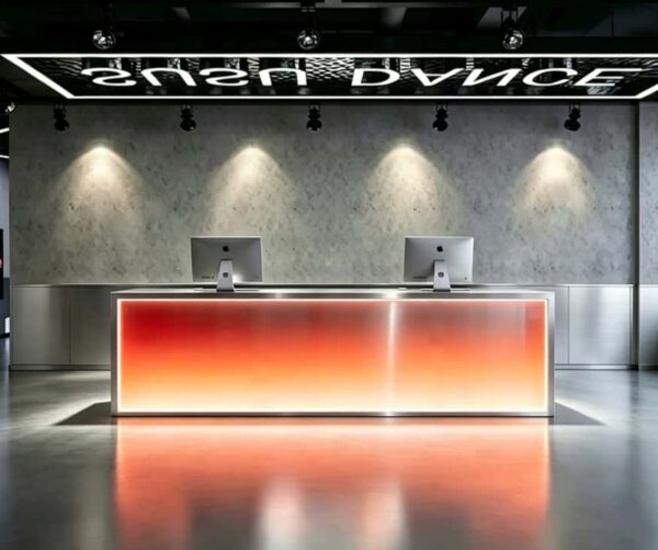 Red-orange glowing LED reception table, custom studio lobby front desk with metal frame