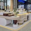 Modern Wavy Shape Jewelry Retail Kiosk, Gold Stainless Steel Frame Jewellery Display Counter
