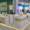 Modern Wavy Shape Jewelry Retail Kiosk, Gold Stainless Steel Frame Jewellery Display Counter