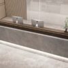 Top angled view modern stone veneer reception desk, grey marble texture front panel, dark wood top with bottom LED strip lighting for corporate lobby