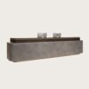 Top angled view modern stone veneer reception desk, grey marble texture front panel, dark wood top with bottom LED strip lighting for corporate lobby