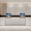 Back side view of reception desk, white lockable storage cabinet with drawers and open compartments for office storage