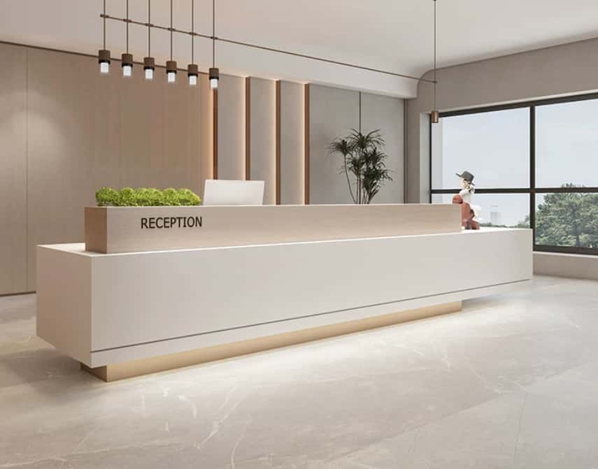 Wide shot minimalist white reception desk inside bright contemporary office lobby with pendant lighting and green plants