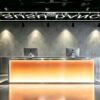 Warm amber gradient light reception counter, commercial furniture for fitness studio reception area